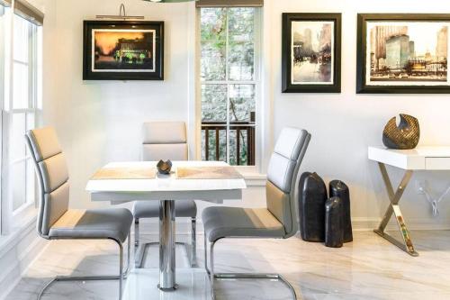 a dining room with a white table and chairs at Private Luxury Suite with Hot Tub Downtown Eureka Springs in Eureka Springs