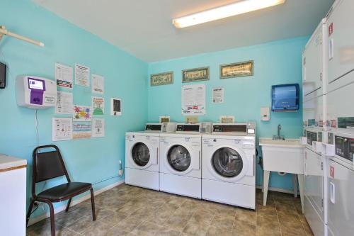 a laundry room with a washer and dryer and a chair at Whalers Rest in Forfar