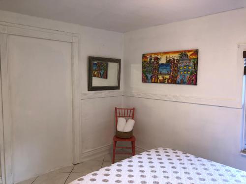 a bedroom with a bed and a chair at Cozy Room in the Heart of Little Havana -3V in Miami