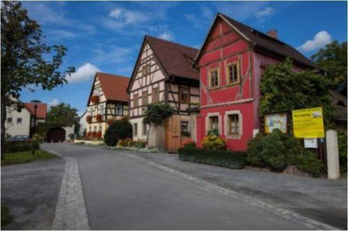 una casa roja al lado de una calle en Pension-Kleint-Wohnung-1, en Radebeul
