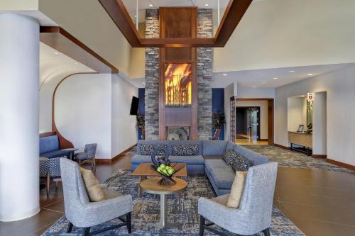 a living room with a blue couch and chairs at Hyatt Place San Antonio North Stone Oak in San Antonio