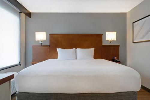 a large white bed in a room with two lamps at Hyatt Place San Antonio North Stone Oak in San Antonio