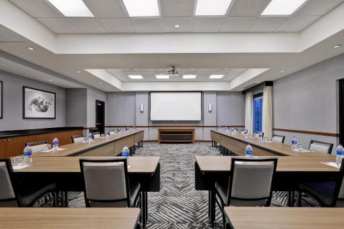 a conference room with tables and chairs and a whiteboard at Hyatt Place San Antonio North Stone Oak in San Antonio