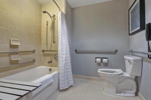 a bathroom with a toilet and a tub and a shower at Hyatt Place San Antonio North Stone Oak in San Antonio