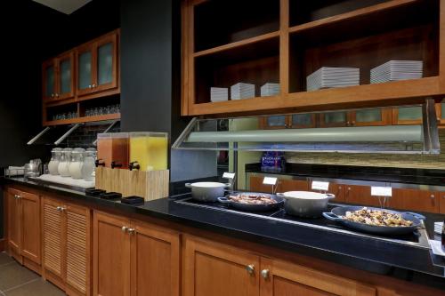 a kitchen with bowls of food on a counter at Hyatt Place San Antonio North Stone Oak in San Antonio