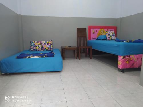 Кровать или кровати в номере Omah Kost Family Syariah
