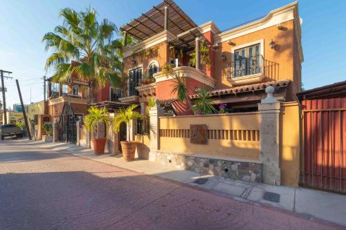 a street with houses and palm trees on a street at Posada del Cortes in Loreto