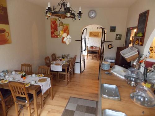 a kitchen and dining room with tables and chairs at Hotel Talburg in Heiligenhaus