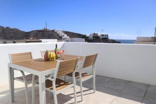 a table and chairs on a balcony with a view of the ocean at Trisara - Las Playitas in Las Playas