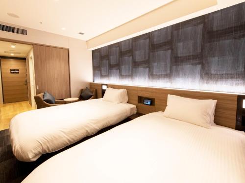 מיטה או מיטות בחדר ב-Kawagoe Tobu Hotel