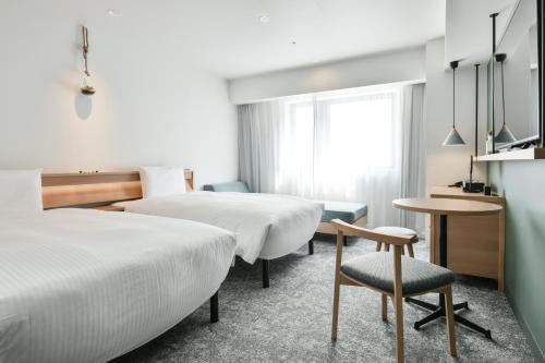 Postel nebo postele na pokoji v ubytování REF Omiya by VESSEL HOTELS