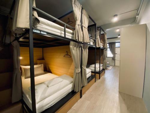 a group of bunk beds in a room at Bangpho Story in Bangkok