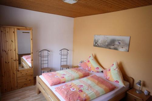 Neudorf的住宿－Grosse-Ferienwohnung-Ebert-Green，一间卧室配有一张床和两把椅子