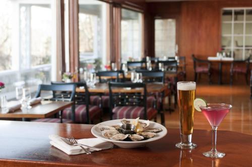 a table with a bowl of food and a glass of beer at Black Point Inn in Scarborough