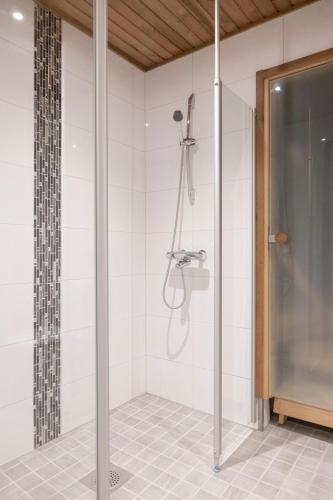a shower in a bathroom with a shower stall at Easy Housing Raahe in Pattijoki