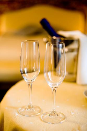 two wine glasses sitting on top of a table at Hotel Cascina Di Corte in Venaria Reale