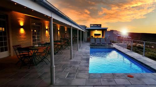 a swimming pool on the side of a building at Rooiberg Wild Private Game Reserve in Ladismith