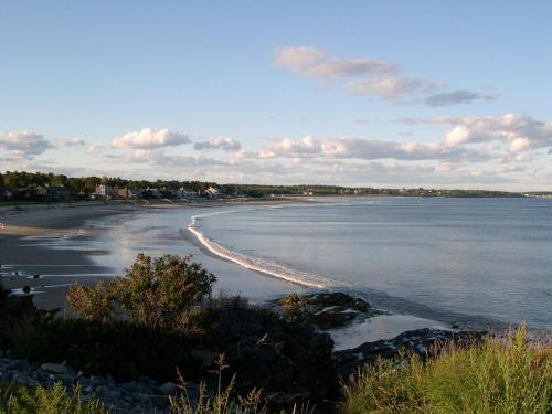 a view of a beach with rocks and water at Black Point Inn in Scarborough