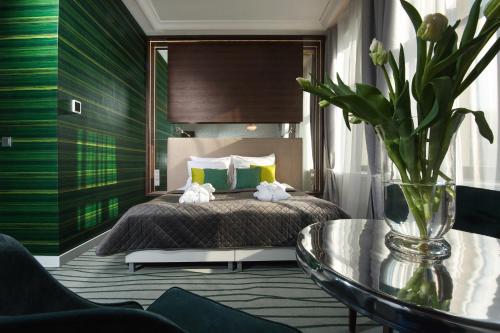 a bedroom with a bed and a glass table at Plaza Boutique Hotel in Kraków