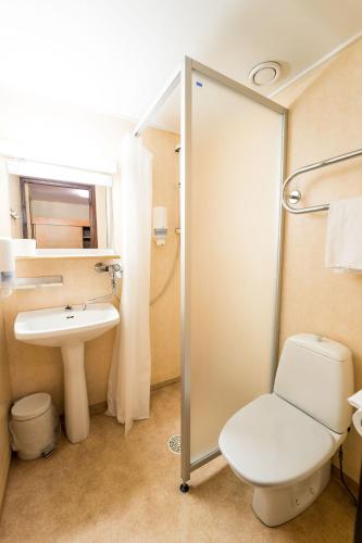 a bathroom with a toilet and a sink and a shower at Budget Hotel Raahe in Raahe
