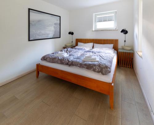 a bedroom with a bed with a wooden frame at Apartment Close to the Beach in Flensburg