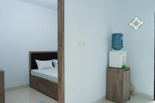 a room with a bed and a mirror with a heater at hotel padma tangerang in Tangerang
