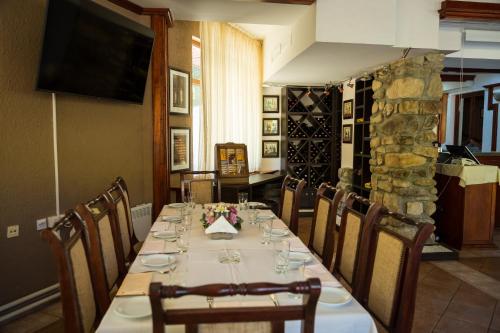 a dining room with a long table with chairs at Idila in Kruševac