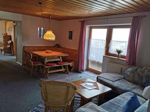 ein Wohnzimmer mit einem Sofa und einem Tisch in der Unterkunft Haus Haidweg Wohnung 4 in Haidmühle