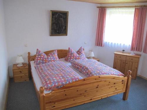 a bedroom with two beds and a window at Ferienhaus-Haidweg-Wohnung-6 in Haidmühle