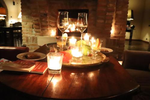 a wooden table with wine glasses and candles on it at Bonello in Gaiba