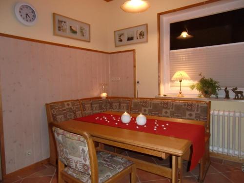 een kamer met een tafel met een rode doek erop bij Traumhafte-Ferienwohnung-Kaethi in Flensburg