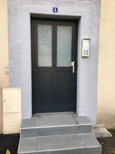 a black door with steps in front of a building at Auguste, La Romaine et My César - Location Saverne in Saverne