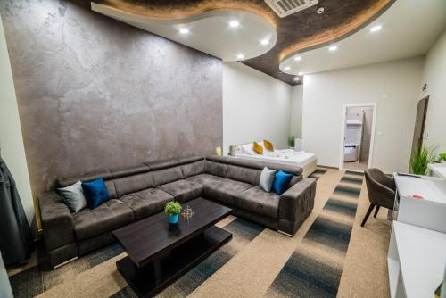 a living room with a couch and a table at Hotel River in Bijeljina
