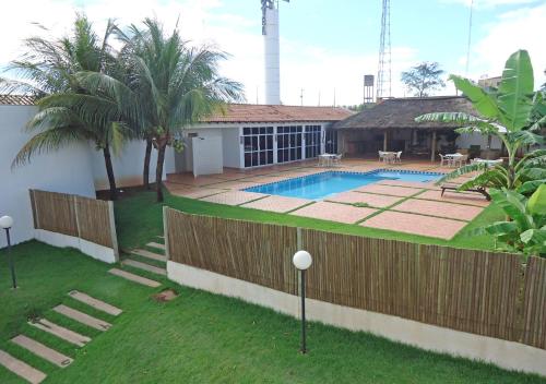 a house with a swimming pool in a yard at Bravo City Rondonópolis in Rondonópolis
