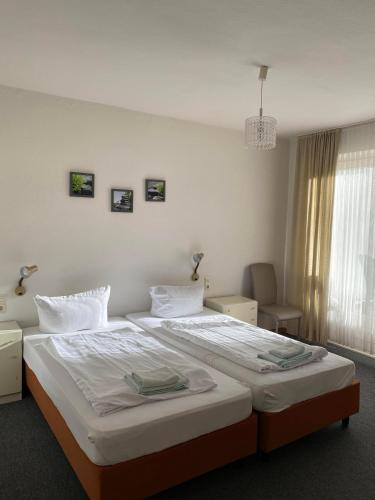 a bedroom with a large bed in a room at Hotel Seehaus in Horn-Bad Meinberg