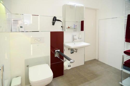 a bathroom with a toilet and a sink at Ferienwohnung-Marion in Ennepetal