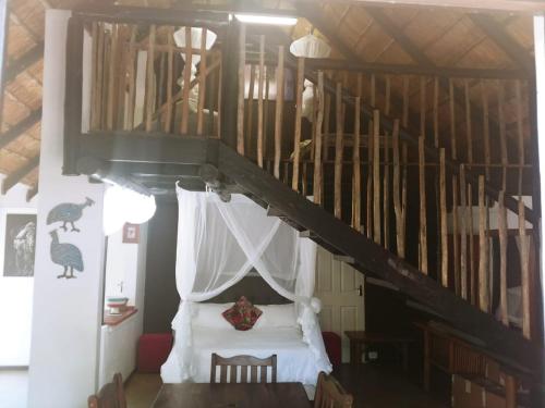 a bedroom with a bed with a white canopy at Pumusa Bushcamp in Hluhluwe