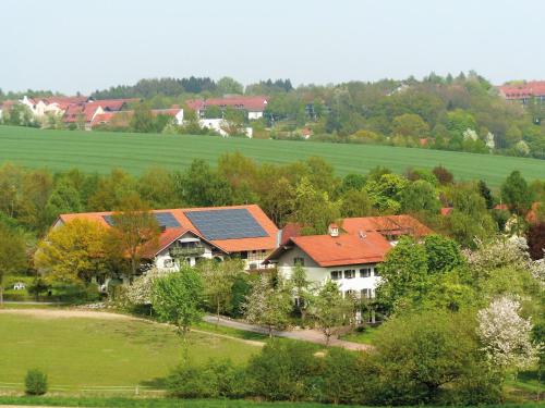 an aerial view of a house with roofs at Gut Schwarz-n Hof Ferienwohnungen in Bad Griesbach