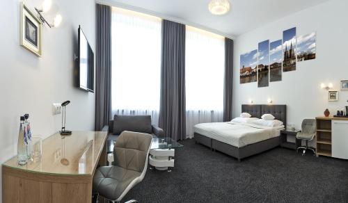 a hotel room with a bed and a desk at InterHotel in Wrocław