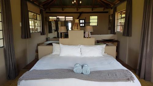 a bed with two pairs of shoes sitting on it at Wide Horizons Mountain Retreat in Malkerns