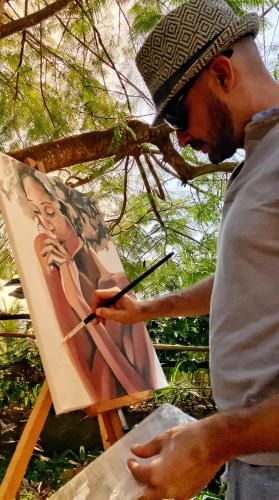 a man painting a picture of a woman on a canvas at Kibanda Natural Kendwa Villa in Kendwa