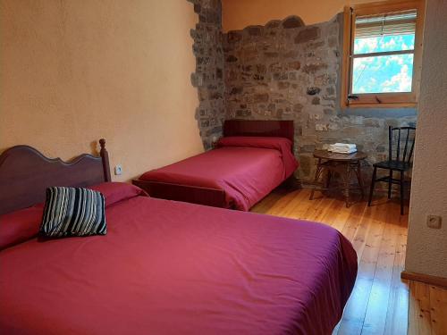A bed or beds in a room at Casa Rural Más Pujol