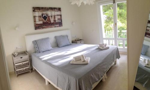a bedroom with a large bed with towels on it at Villa La Buena Vida in Benissa