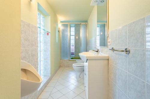 a bathroom with a sink and a toilet and a tub at Casa Vista mare Bosa/Magomadas in Magomadas