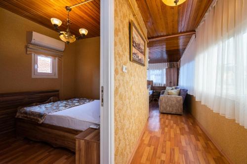 a bedroom with a bed and a chair in a room at Kervanchi in Istanbul