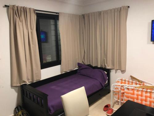Un dormitorio con una cama morada y una ventana. en COMPLEJO AYRES DE MAYU SUMAJ, en Villa Carlos Paz