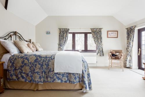 a bedroom with a bed and a window with curtains at The Willows in Christchurch