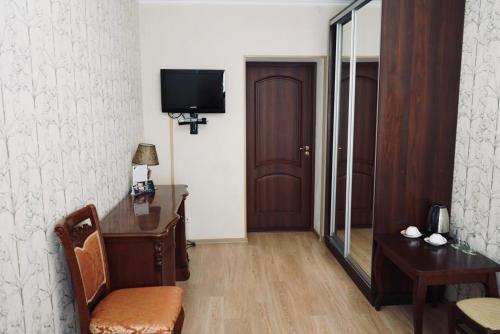 a room with a desk and a tv on a wall at Evropeyskiy in Kyiv