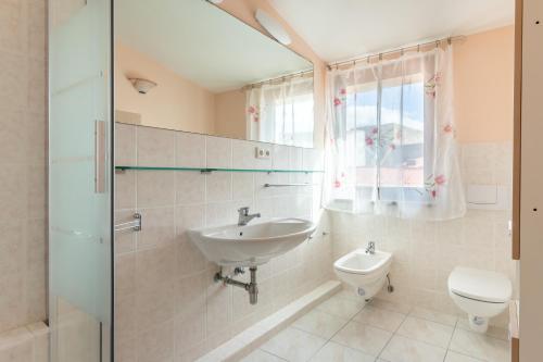 a bathroom with a sink and a toilet at Casa Vista mare Bosa/Magomadas in Magomadas