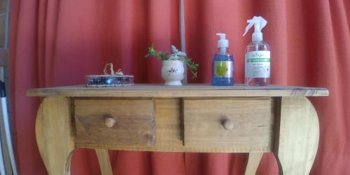 a wooden table with two bottles on top of it at Nelumbo Petit Chalet in San Rafael